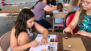 A young girl working on electronics at our play museum