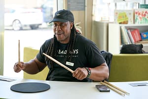 man teaching drumming