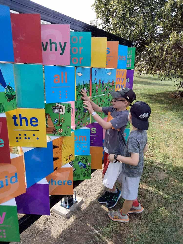 playful learning kids at a wall of art