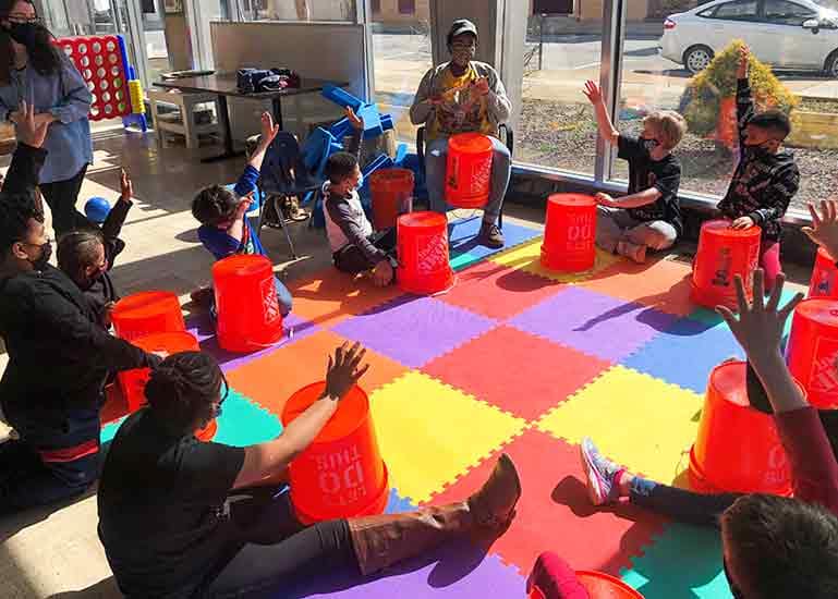 Kids with buckets in a play circle
