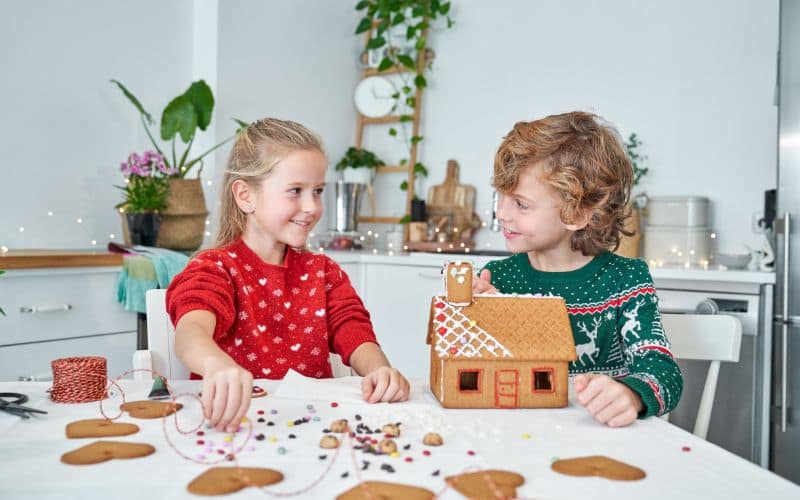 children making gingerbread house